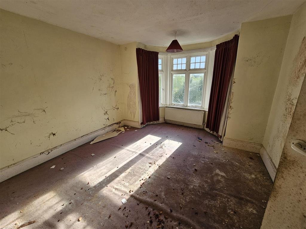 A £450,000 Winchester home with boarded windows, blackened walls and renovation needs is up for auction, with buyers advised to bring a torch and wear sturdy shoes.